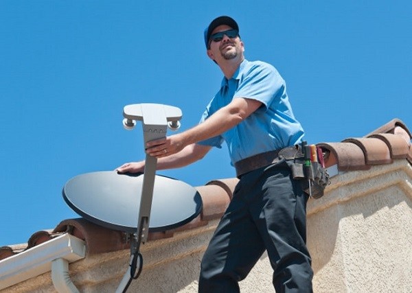 Man installing a satellite dish.